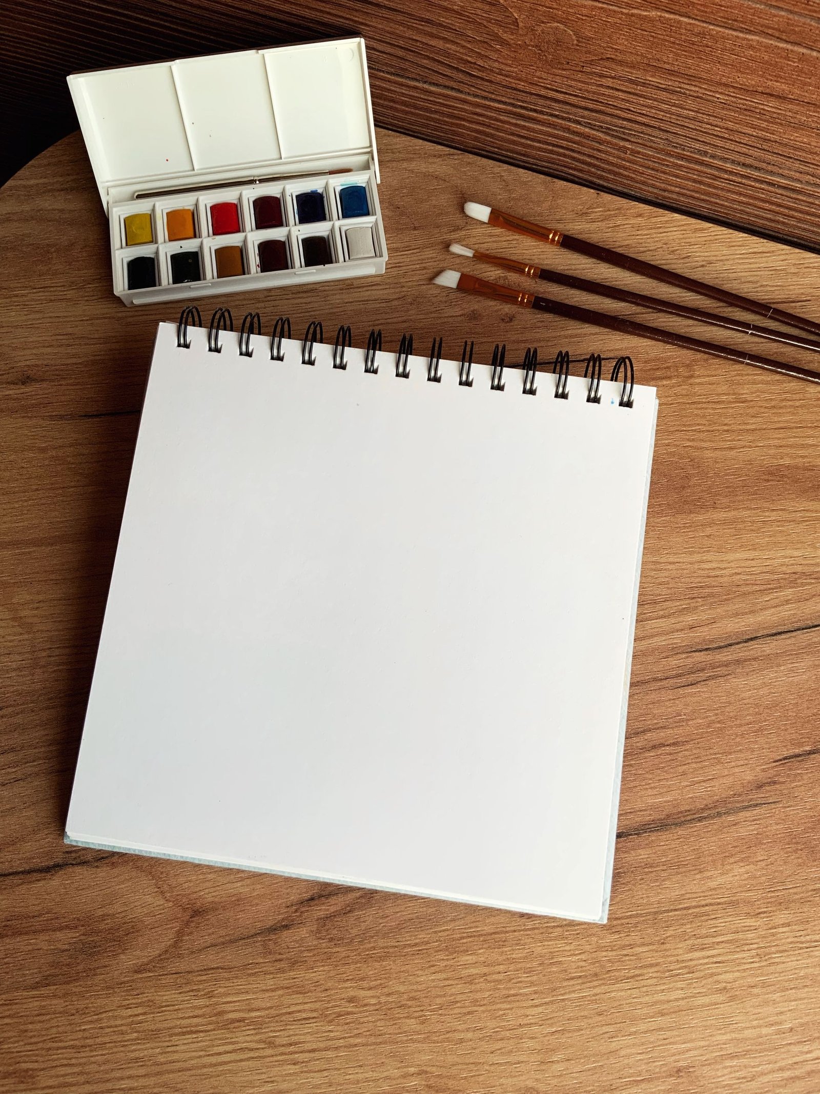Spiral-bound canvas pad on a studio table