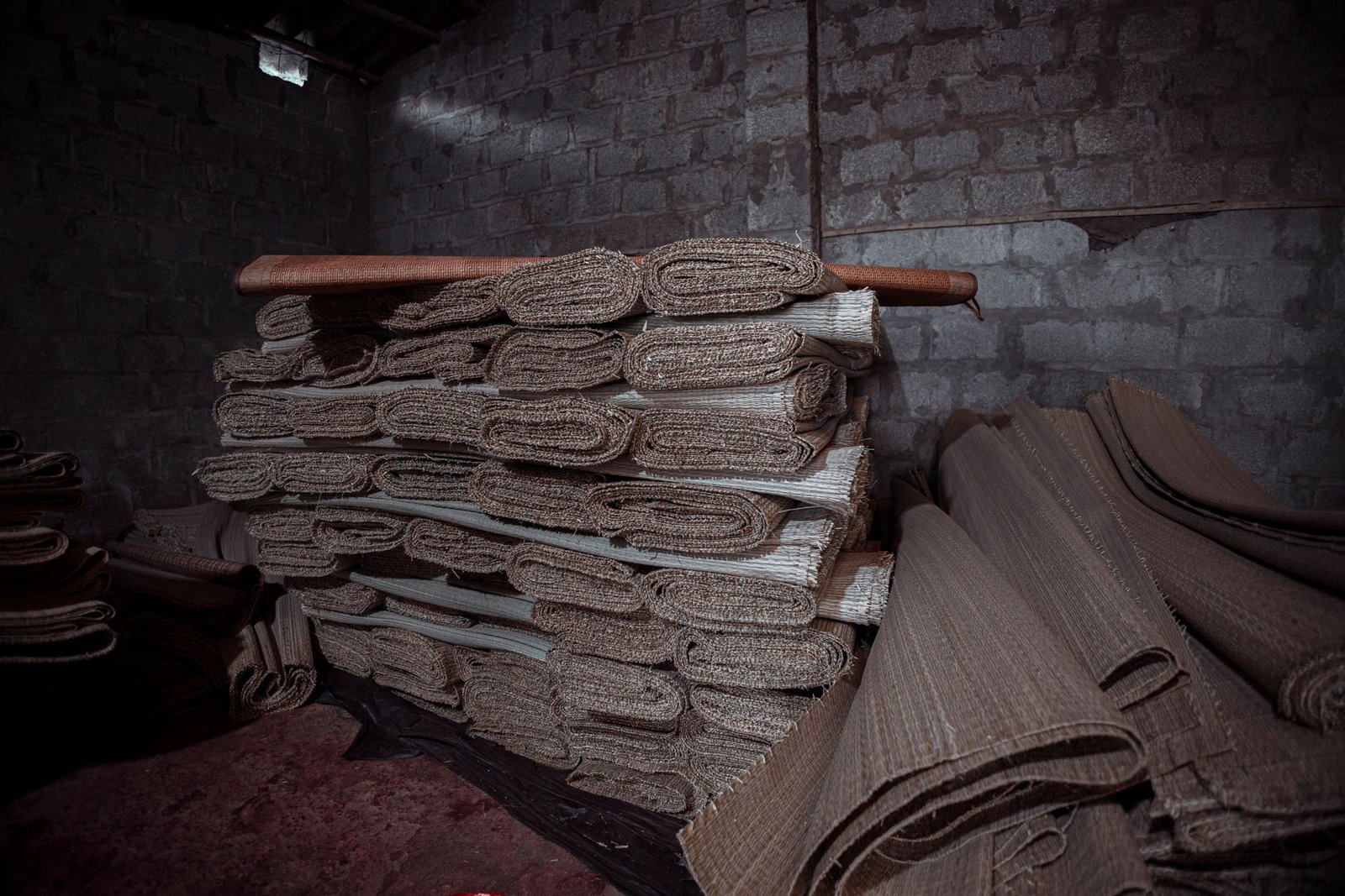 Warehouse stacked with canvas rolls and stretcher bars